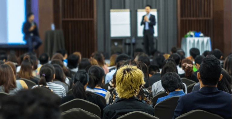 Audience attending a conference presentation.